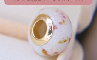 Breastmilk bead with gold bead cores, pearl white shimmer and pink opal, gold flecks