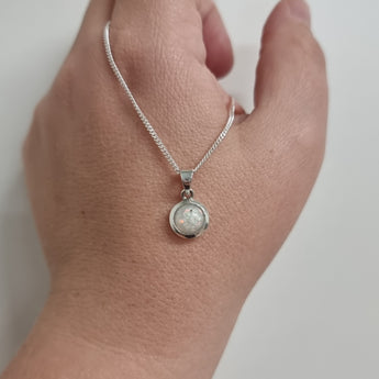 Front view, pearl white shimmer, lightly sprinkled ashes and white crushed opal 8mm pendant