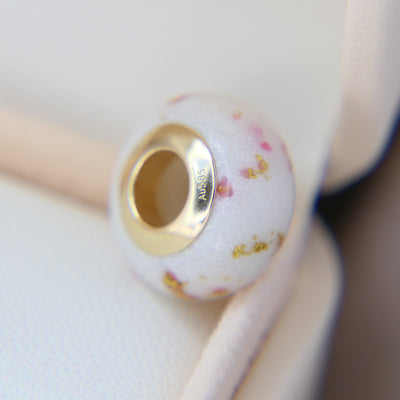 Breastmilk, pearl white shimmer, gold flecks ( subtle) and pink opal , yellow gold bead