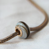 Breastmilk, pearl white shimmer and white opal, Gold flecks (subtle) and hair bead, rose gold bead