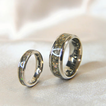 Titanium Matching narrow and wide band keepsake rings with cremations and crushed white opal