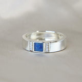 Lightly sprinkled ashes, sapphire blue, silver band