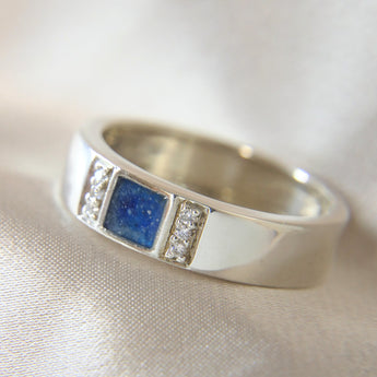 Lightly sprinkled ashes, sapphire blue, silver band