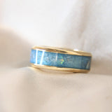 Yellow gold band, lightly sprinkled ashes, subtle opalescent flecks, light blue shimmer