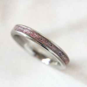 Lightly sprinkled ashes, briar rose pink shimmer, subtle black flecks, titanium band