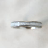 Lightly sprinkled ashes, pearl white shimmer, titanium band