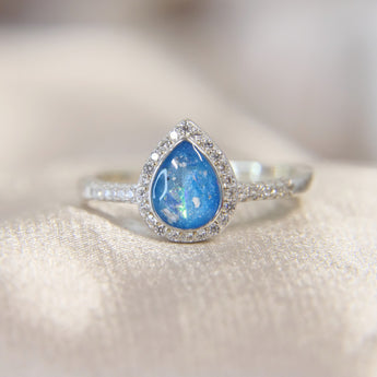 Lightly sprinkled ashes, light blue shimmer, subtle opalescent flecks