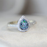 Lightly sprinkled ashes, pearl white shimmer, black flecks, ocean green opal