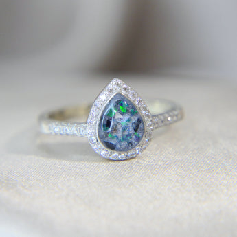 Lightly sprinkled ashes, pearl white shimmer, black flecks, ocean green opal