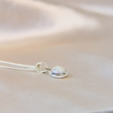 Pearl white shimmer, lightly sprinkled ashes 8mm pendant side view