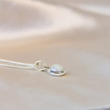 Pearl white shimmer, lightly sprinkled ashes 8mm pendant side view
