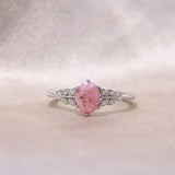 Light pink oval cremation ring- lightly sprinkled ashes
