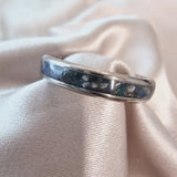 Titanium band, heavy ashes, charcoal shimmer, cobalt blue opal, blue flecks