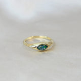 Gold marquise ring with forest green shimmer, heavy ashes, and ocean green opal