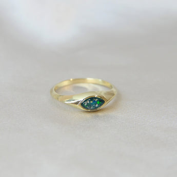 Gold marquise ring with forest green shimmer, heavy ashes, and ocean green opal