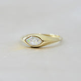 Gold marquise ring with pearl white shimmer, heavy ashes, and white opal