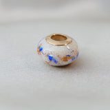 Rose gold bead, breastmilk, no shimmer, heavy rose gold flecks, cobalt blue opal