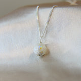 Lightly sprinkled ashes, crystal white shimmer, subtle opalescent flecks