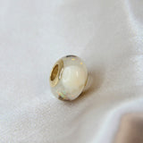 Gold bead, tooth, umbilical cord and white opal