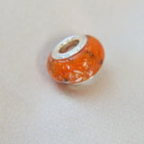 Heavy ashes, saffron orange shimmer subtle black opal (has red reflections)