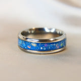 Titanium band, light blue shimmer, heavy ashes, subtle silver flecks, white opal