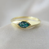 Gold marquise ring with forest green shimmer, heavy ashes, and ocean green opal