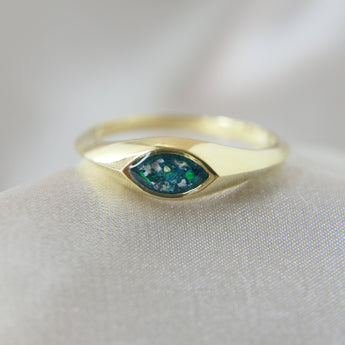 Gold marquise ring with forest green shimmer, heavy ashes, and ocean green opal
