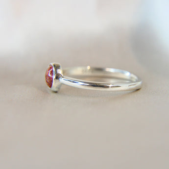 Side view ruby red shimmer, heavy sprinkled ashes