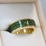 Yellow gold band, olive green shimmer, subtle opalescent flecks, hair, light ashes