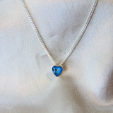 Lightly sprinkled ashes, light blue shimmer, subtle opalescent flecks