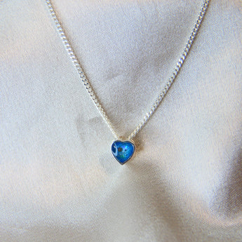 Lightly sprinkled ashes, light blue shimmer, subtle opalescent flecks