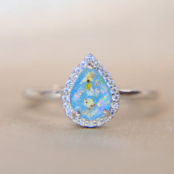 Light blue shimmer, heavy ashes, subtle opalescent flecks and white opal