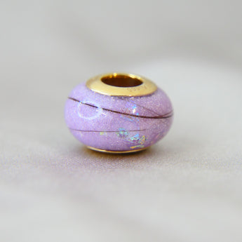 Milk, hair, lavendar grey shimmer, subtle opalescent flecks, gold bead
