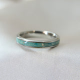 Teal shimmer, subtle blue flecks, lightly sprinkled ashes