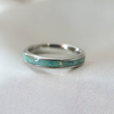 Teal shimmer, subtle blue flecks, lightly sprinkled ashes