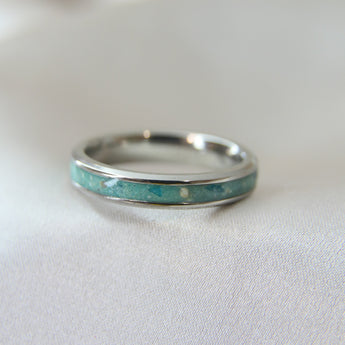 Teal shimmer, subtle blue flecks, lightly sprinkled ashes