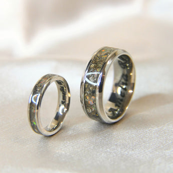 Matching narrow and wide band keepsake rings with heavy cremations and crushed white opal