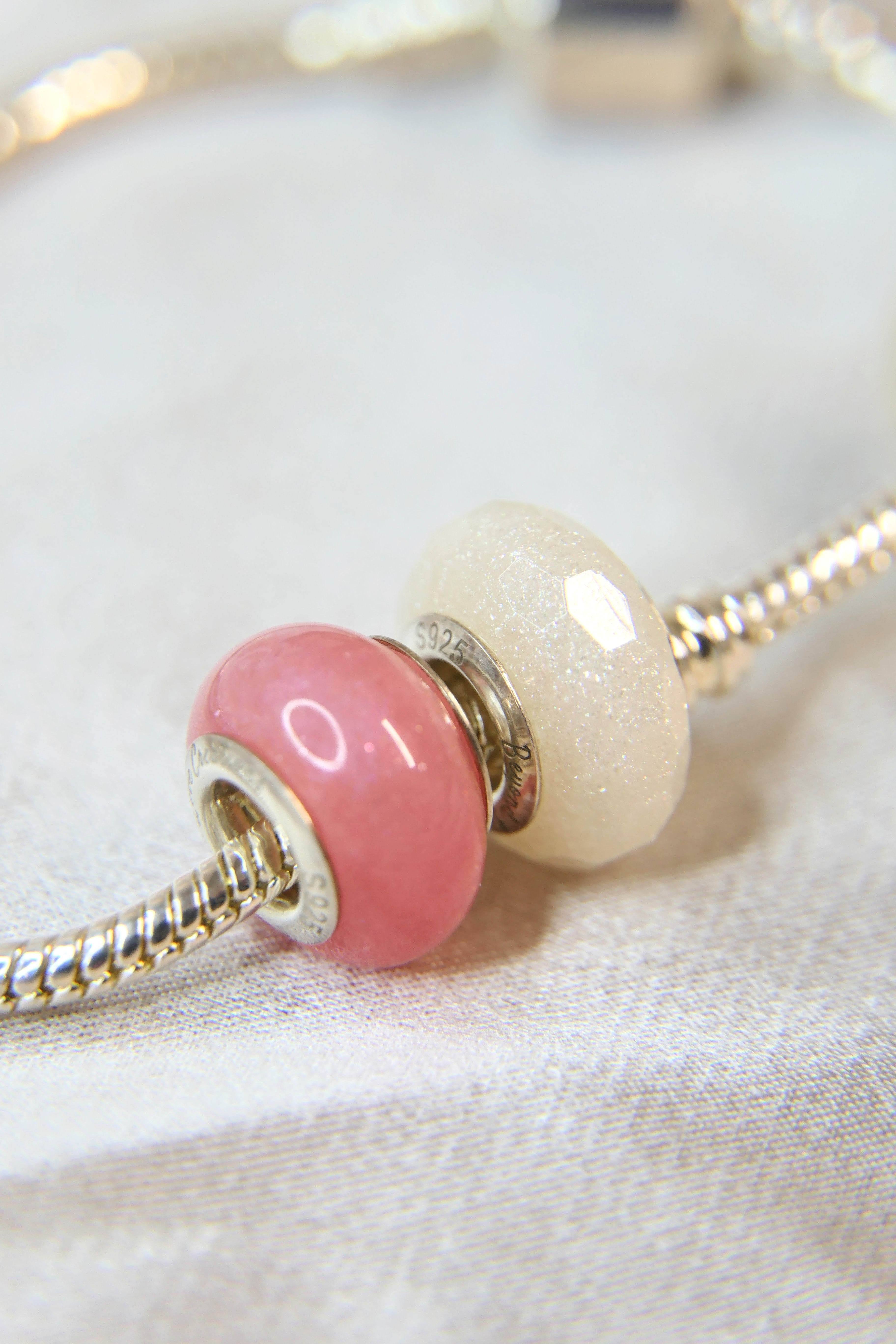 Smooth bead next to faceted bead with crystal shimmer and milk