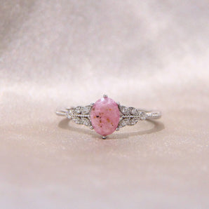 Light pink oval cremation ring- lightly sprinkled ashes 