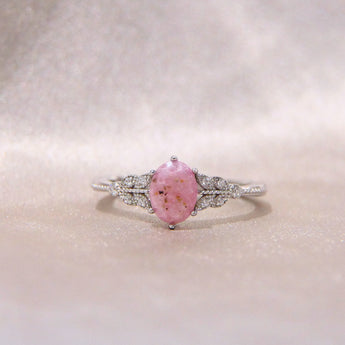 Light pink oval cremation ring- lightly sprinkled ashes 