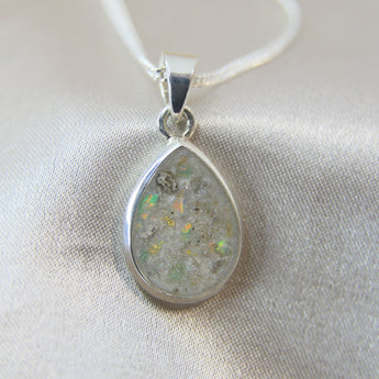 14 x 10mm pendant, pearl white shimmer, heavy ashes ( very fine ashes) subtle gold fleck and aquamarine mint opal