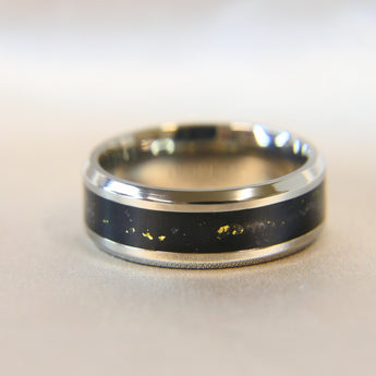 Titanium band, barely visible ashes, black shimmer, subtle gold flecks 