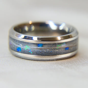Titanium band, charcoal grey shimmer, subtle opalescent flecks, cobalt blue opal, hair, light ashes 