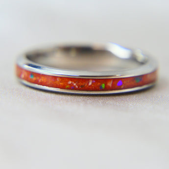 Titanium band, saffron orange shimmer , lightly sprinkled ashes and ocean green opal 