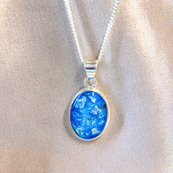 14 x 10 cremation pendant- light blue shimmer, heavy ashes, subtle opalescent flecks