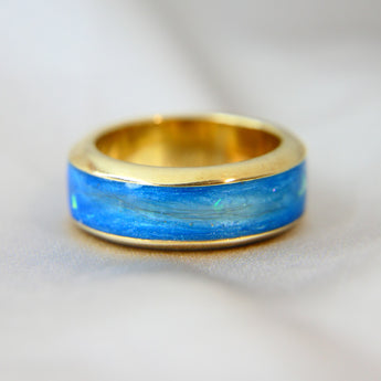Yellow gold band, light blue shimmer, hair, subtle opalescent flecks 