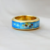 Yellow gold band, light blue shimmer, heavy opalescent flecks, mustard seeds