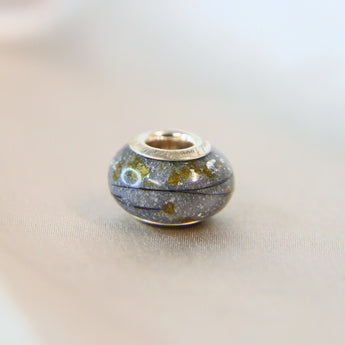 Silver bead, charcoal grey shimmer, breastmilk, hair and umbilical cord, subtle silver flecks