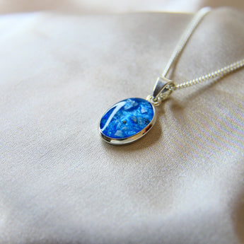 14 x 10 cremation pendant- light blue shimmer, heavy ashes, subtle opalescent flecks