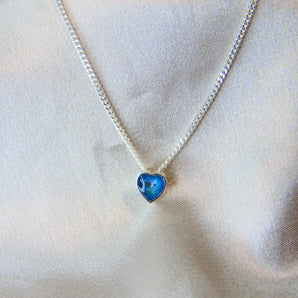 Lightly sprinkled ashes, light blue shimmer, subtle opalescent flecks 
